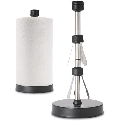 A stainless steel paper towel holder with a weighted base and suction cups, designed for countertop use. It is displayed alongside a roll of paper towel.