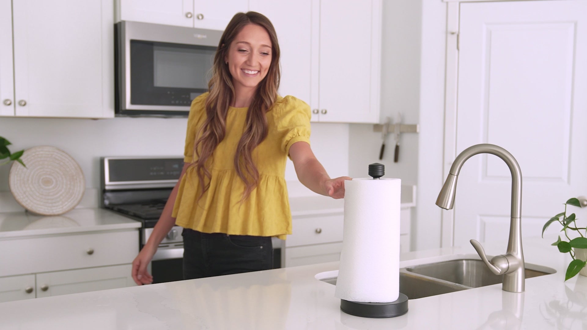 Load video: Video of home owners who purchased the smart paper towel holder and showing how it can be torn with only one hand and that it also stays securely in place.